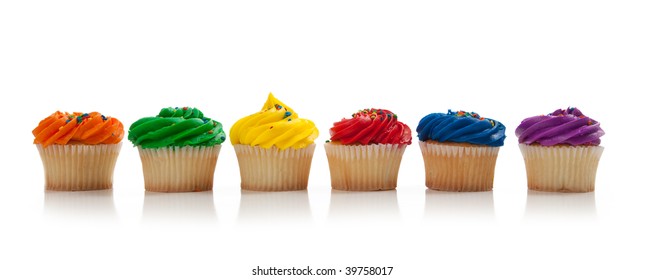 A Red, Green, Blue, Purple, Yellow And Orange Cupcake With Colored Sprinkles On A White Background