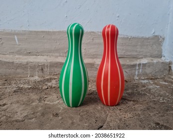 Red And Green Bowling Pin Toys On The Floor