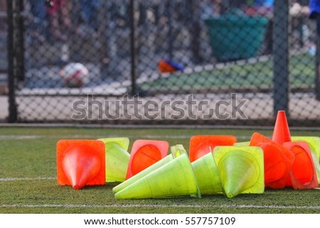 Red and green cones put on the grass floor at the football field
