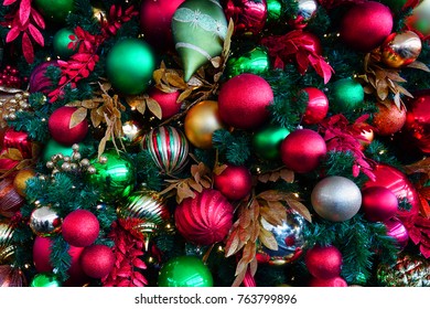 Red And Green Holiday Ornaments On A Christmas Tree