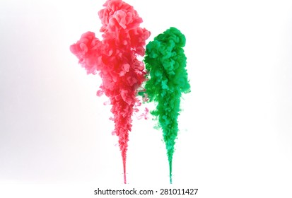 Red and green ink making clouds in water