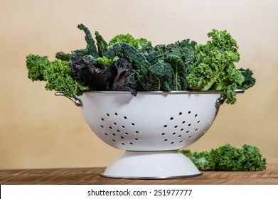 Red and green kale leaves in a white colander - Powered by Shutterstock