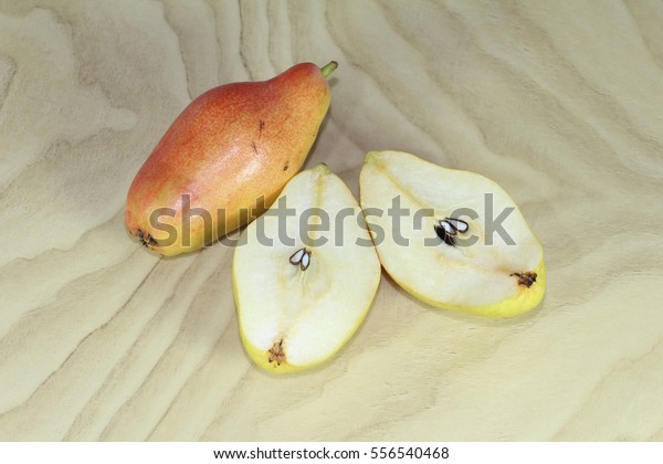 Red\
and green pears, sliced pear on a wooden\
background