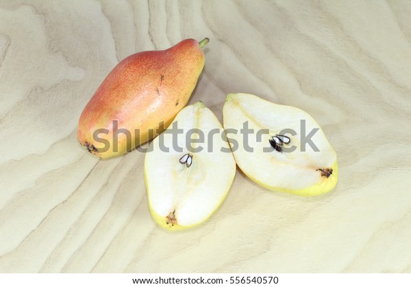 Red\
and green pears, sliced pear on a wooden\
background