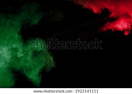 Red and Green Powder Explosion On black Background.