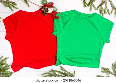 Red And Green T Shirt Mockup With Copy Space And Christmas Holiday Template Flatlay. Top View Blank T-shirt On White Background. Happy New Year Decorations