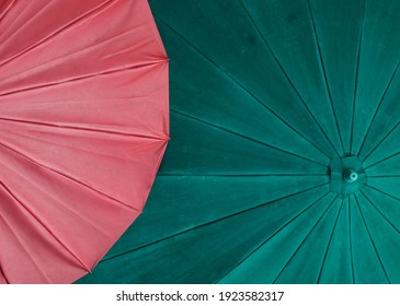 The red and green umbrellas together are pairs of opposite colors. Art backgrounds. Copy space.