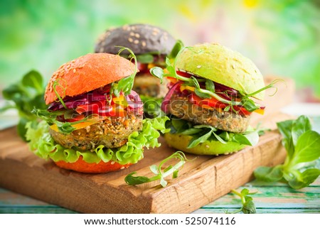 Red, green,black mini burgers with quinoa and vegetables .