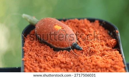 Red groundbait and wafter on method feeder