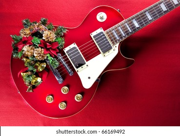 Red Guitar With Christmas Ornaments. Image For Christmas / Holiday Season Music Event.