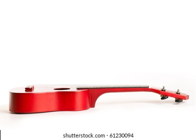 A Red Guitar Laying Down On White Background