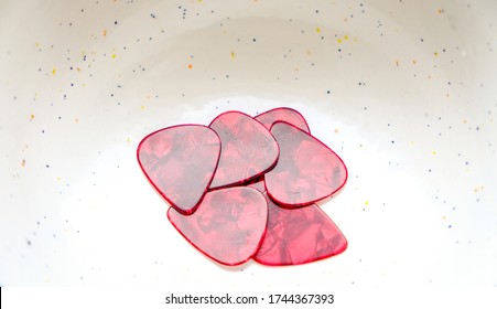 Red Guitar Pics In A Speckled Bowl