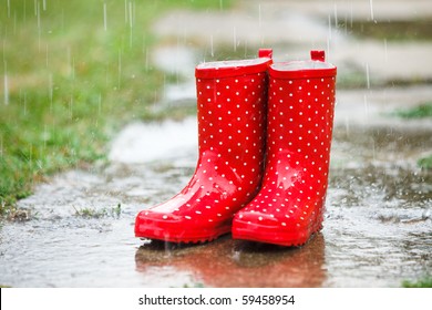 Red Gumboots In Rain Full Of Water