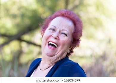 Red Hair Enthusiastic Senior Woman Giving A Genuine Laugh