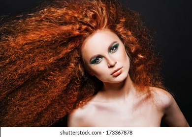 Red Hair. Fashion Girl Portrait. long Curly Hair. green evening make-up 