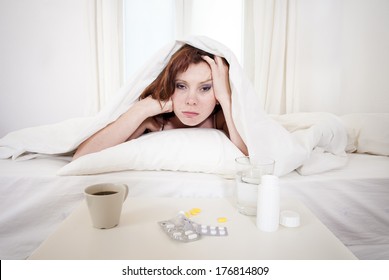 Red Hair Girl Hungover Wanting Coffee And Medication To Help With Her Hungover In Bed