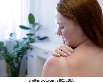 Red hair woman strokes and scratches sunburn skin on back and shoulders. Close-up view of back and shoulders with sunburn marks. Woman with reddened itchy skin. Concept of sunbathe without sunscreen. - Shutterstock ID 2182032887