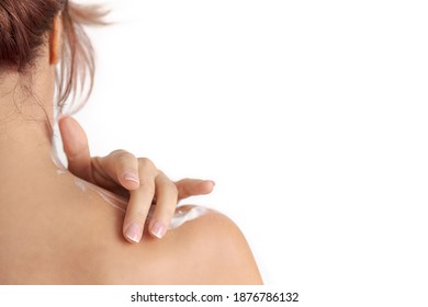 red hair woman's hand applying cream on her shoulder. Self care concept - Shutterstock ID 1876786132