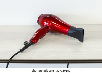 Red Hairdryer On The Shelf