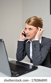 Red Haired Business Woman Having A Difficult Conversation Behind Her Laptop At The Office. 