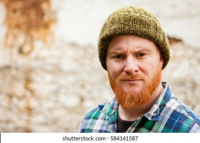 Red Haired Man With Plaid Shirt With A Old Wall With Background