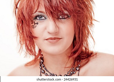 Red haired pretty girl with a tatoo on a cheek