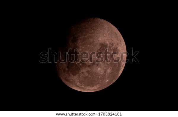 Red half moon close up on night sky background,\
surface moon on black background and not star in sky, moon is\
planet of earth in univers