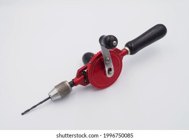 Red Hand Crank Drill With Black Handle On White Background