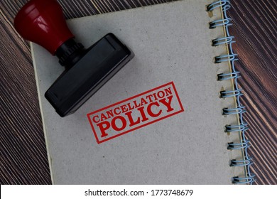 Red Handle Rubber Stamper and Cancellation Policy text isolated on the table.