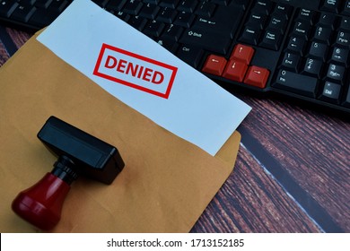 Red Handle Rubber Stamper and Denied text Isolated on wooden table background - Shutterstock ID 1713152185