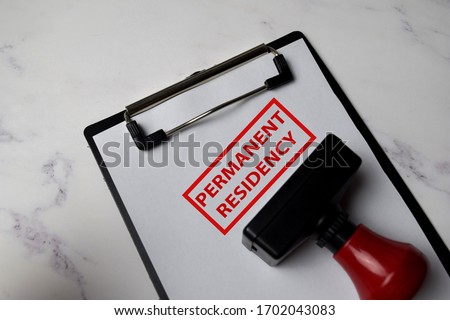 Red Handle Rubber Stamper and Permanent Residency text isolated on White Background.