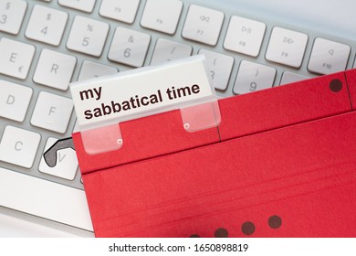 red hanging folder on a keyboard has a tab with the words my sabbatical time on it - Shutterstock ID 1650898819