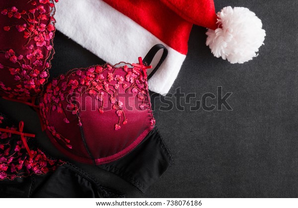 Red hat and bra. Search and choose what kind of lingerie to wear for romantic, intimate Christmas evening night. Women underwear surprise for men. Christmas time concept. Empty place for text. 