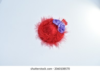 A Red Hat Society Hat With Purple Flowers And Feathers On White Background
