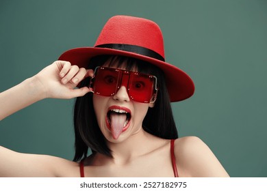 Red hat, red sunglasses, woman making a funny face with her tongue out, expressing playful and quirky emotions in a vivid and colorful scene