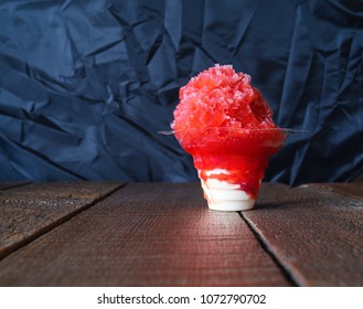 Red Hawaiian Shaved Ice, Shave Ice Or Snow Cone With Ice Cream On The Bottom In A Clear Cup.