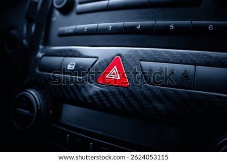 Red hazard warning button on a car