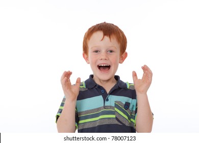 Red Head Boy With Freckles Looking Shocked And Surprised While Smiling And Holding Hands In Air