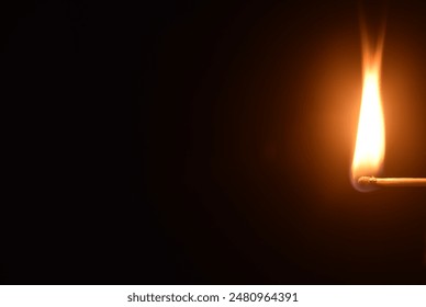 red head matchstick ignite and lighting on in dark background - Powered by Shutterstock