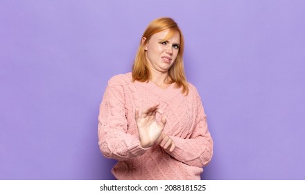 Red Head Pretty Woman Feeling Disgusted And Nauseous, Backing Away From Something Nasty, Smelly Or Stinky, Saying Yuck