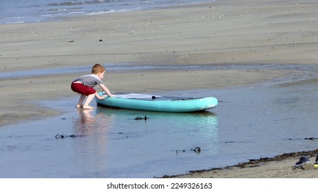 Red headed boy playing on a sandy beach in Northern Ireland Holidays in UK - Shutterstock ID 2249326163