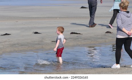 Red headed boy playing on a sandy beach in Northern Ireland Holidays in UK - Shutterstock ID 2249326165