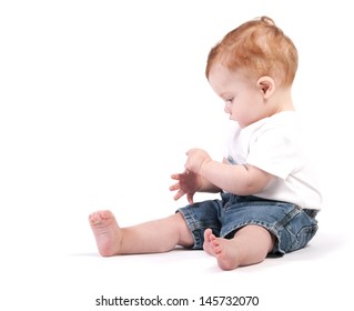 A Red Headed Toddler Counting His Fingers On A White Back Ground