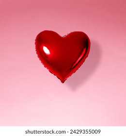 Red heart balloon on pinkbackground. Minimal love concept.