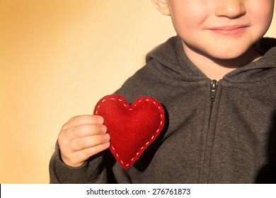 Red Heart In Child Hands. Kindness Concept, Gift, Hand Made Valentine, Close Up, Horizontal, Copy Space