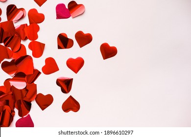 Red heart confetti on February 14 for Valentine's Day.