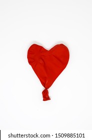 Red Heart Deflated Balloon On White Background