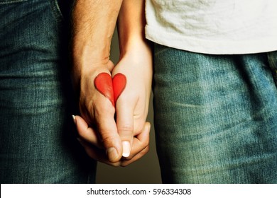 red heart drawing on hands of a couple holding hand in hand, lovers, symbol of love, togetherness, hands holding, love, valentine