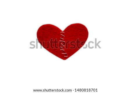 Red heart fabric with white threads on white background, isolated. The concept of Sadness, unhappy love, broken heart.