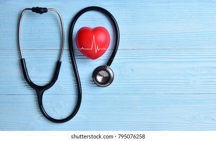 Red Heart With Heartbeat Or Heart Rate And Stethoscope On Blue Wooden Background. Copy Space. Medical And Health Care, Valentines Day.